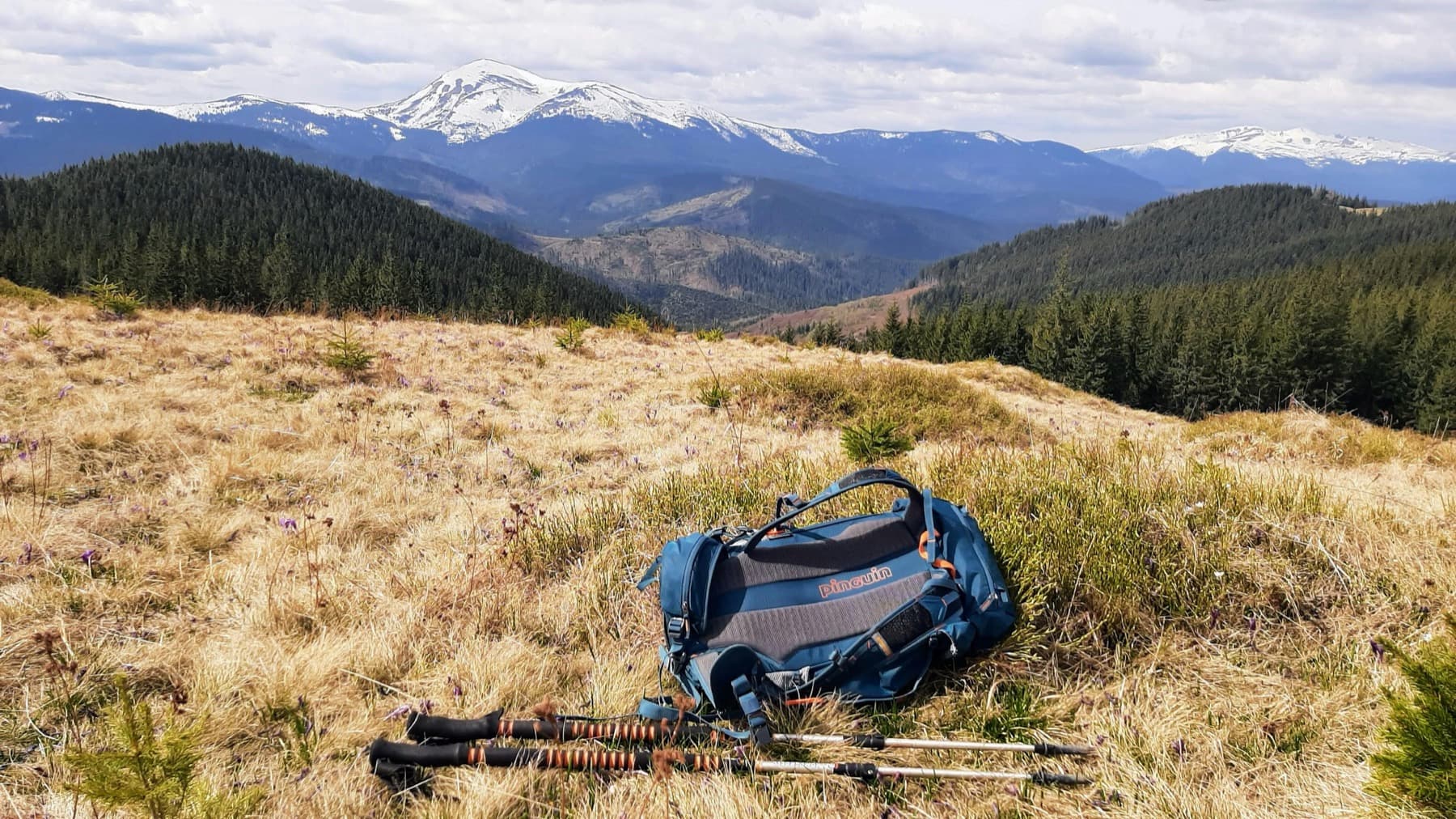 Mountain summit pack staged against a Colorado alpine ridge at first light.